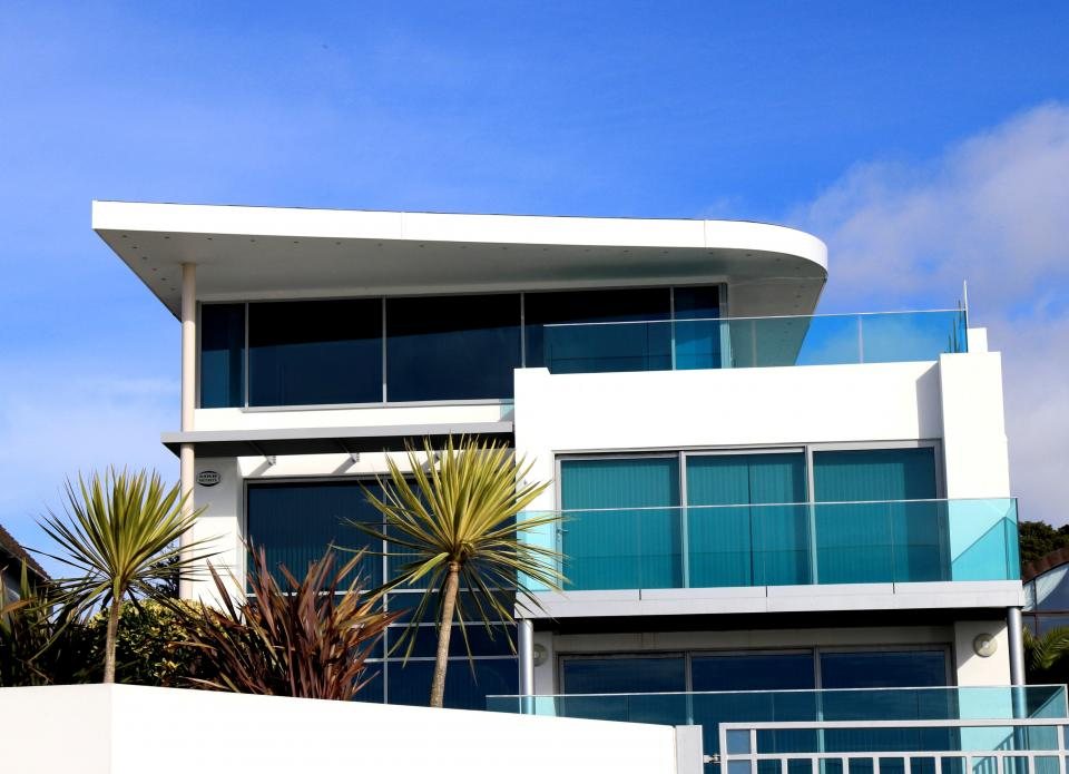 White coastal house with glass balustrades