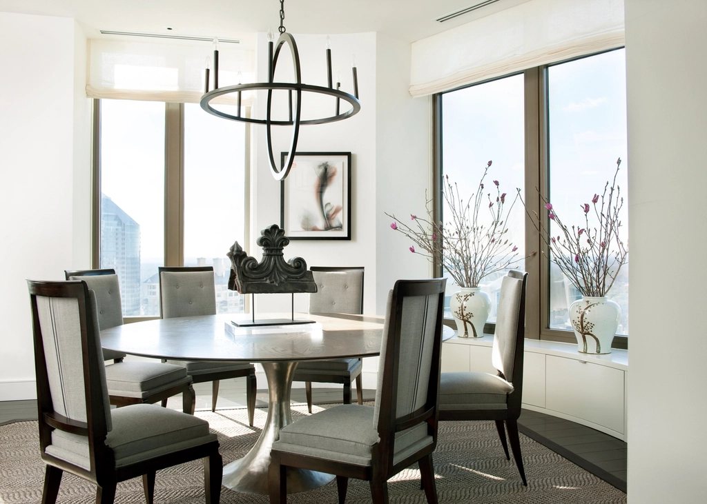 Round dining table by tall windows