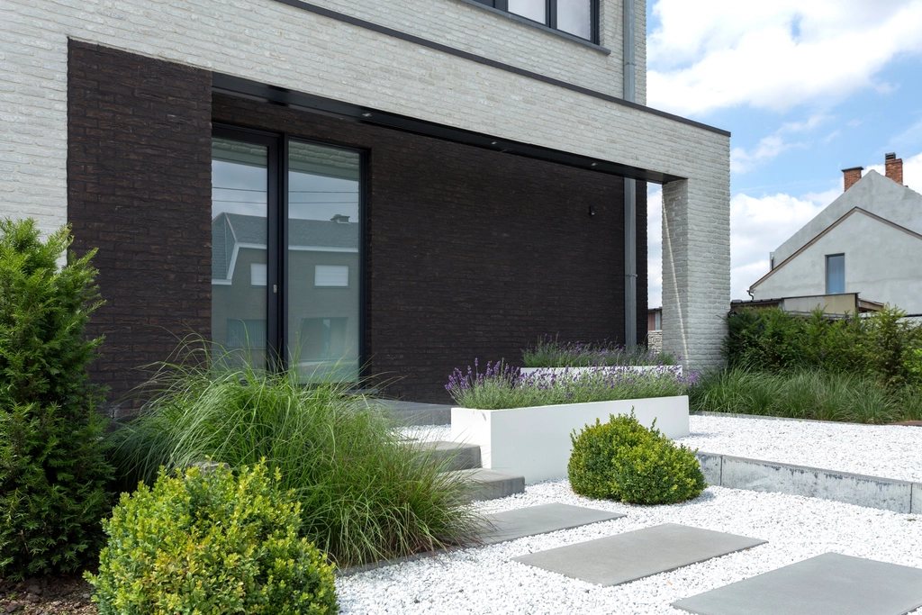 Brick house above a planted gravel garden