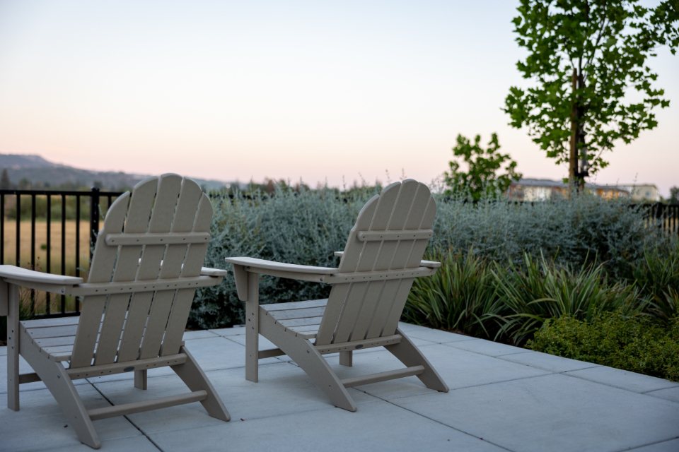 Terrace chairs facing a dry garden