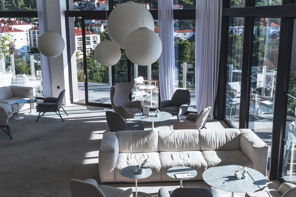 Lounge with globe lights and tall windows
