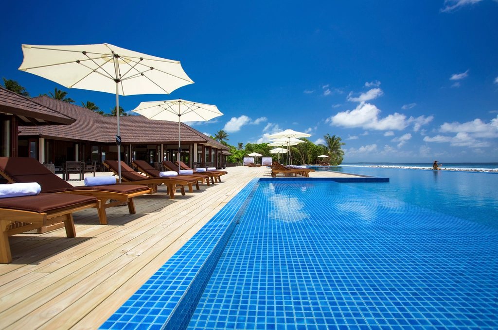 Long tiled pool and timber deck by the sea