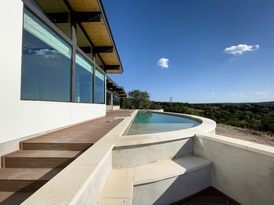 Curved infinity pool on a stone terrace