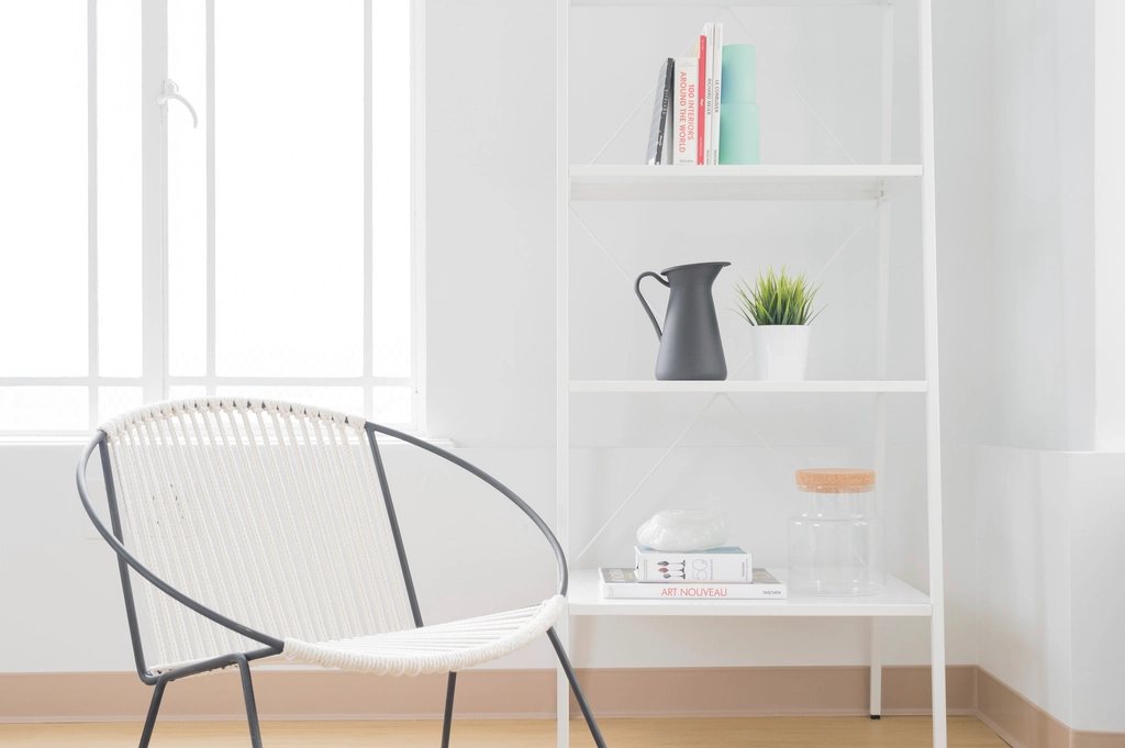 White reading corner with a wire chair