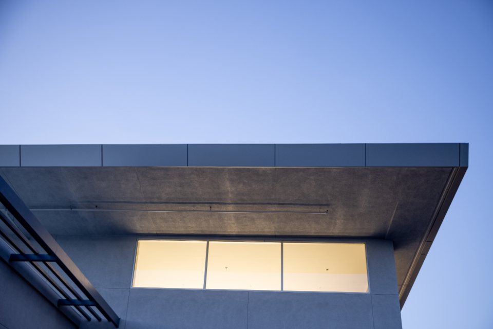 Deep roof overhang above a lit clerestory