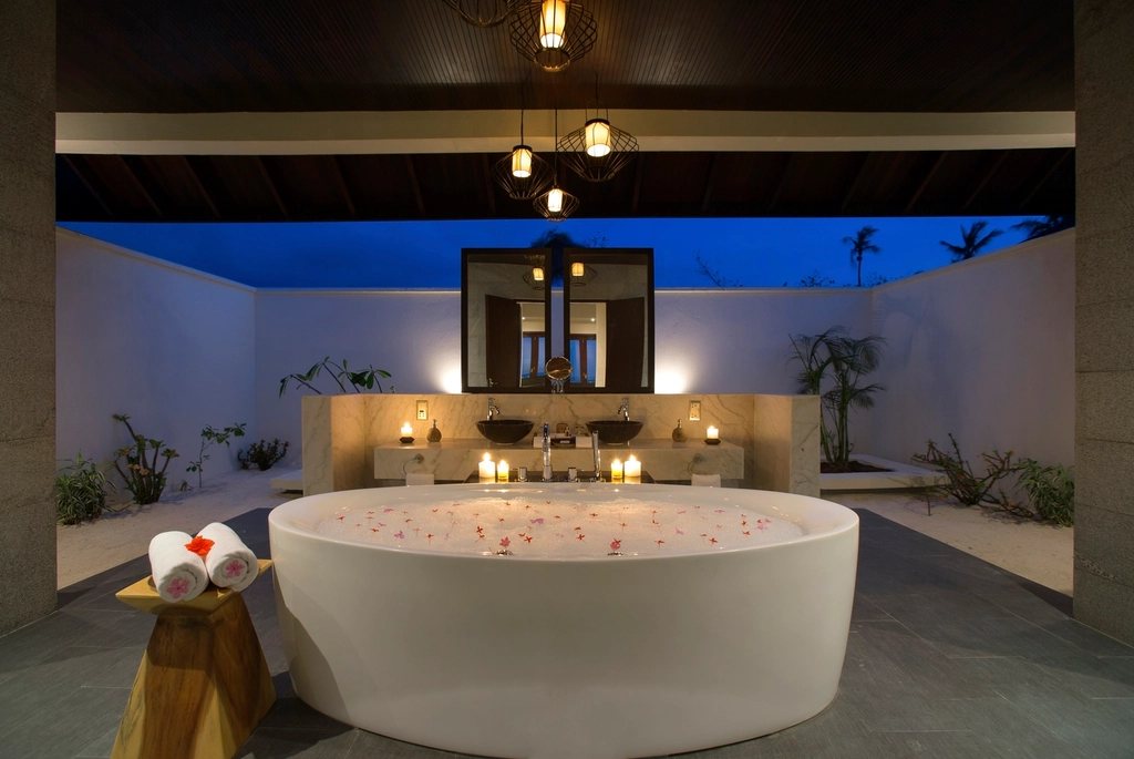 Round bath in a candlelit spa room
