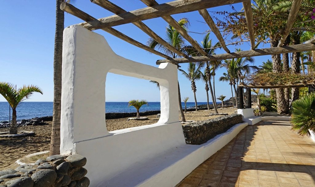 White wall and pergola on the shore