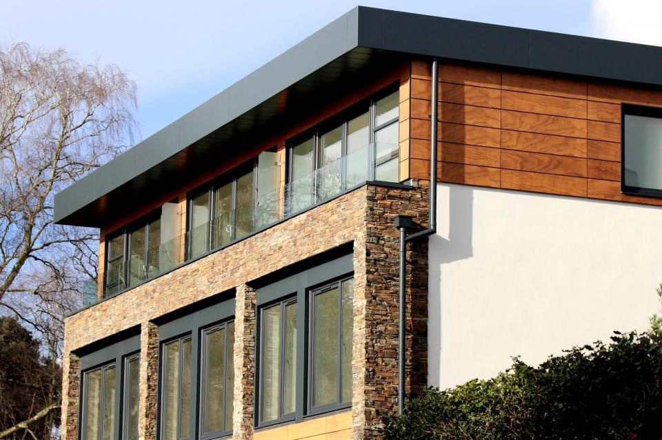 House of stone, render and timber cladding