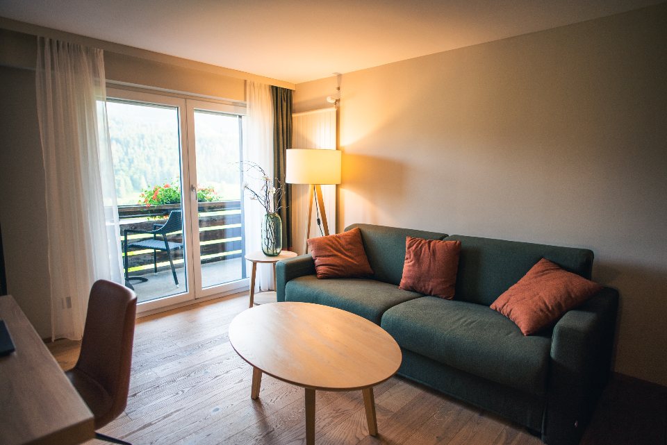 Living room with a green sofa at dusk